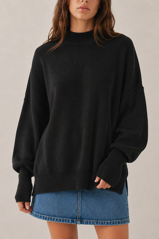 Person wearing a black sweater and denim skirt on a neutral background