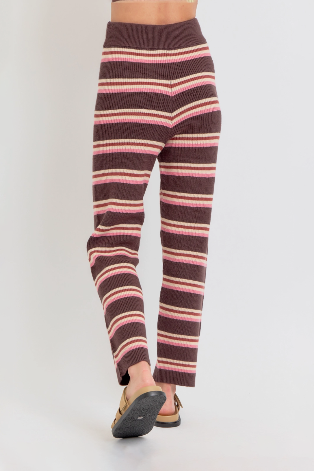 Striped leggings with pink and brown pattern on a white background