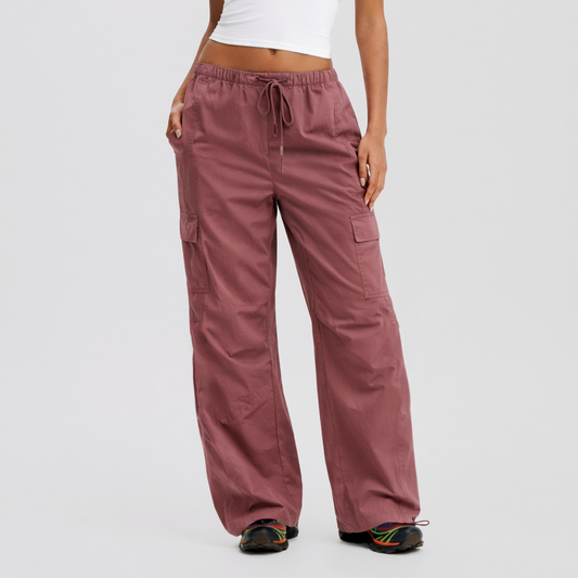 Mauve cargo pants worn by a person on a white background