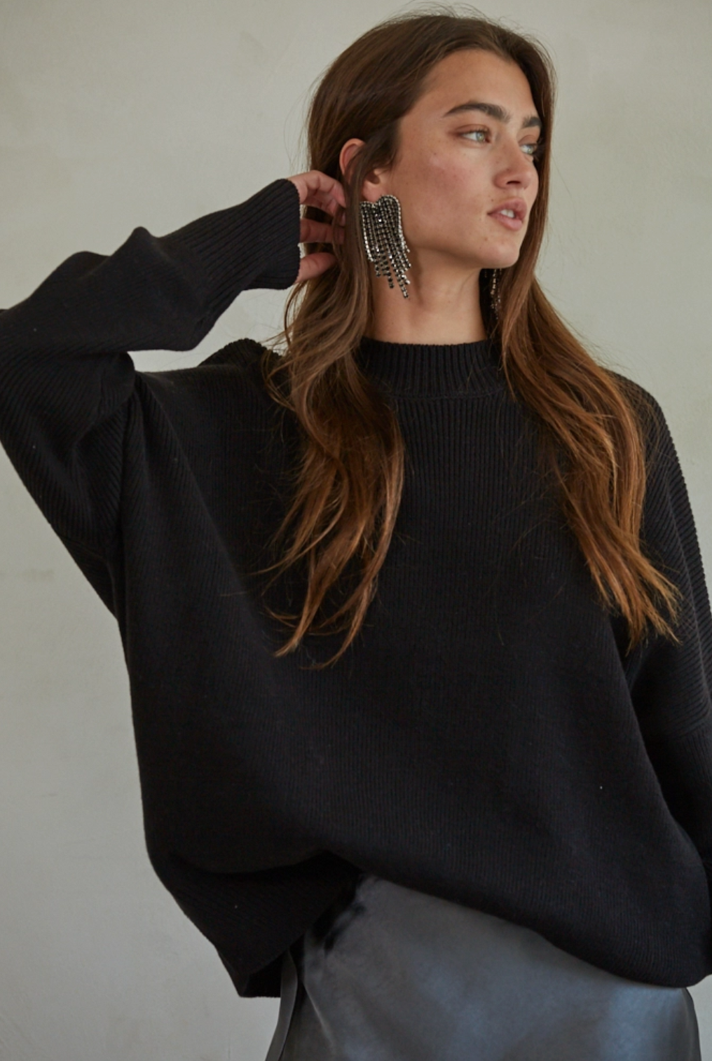 female model wearing ribbed black mock neck sweater