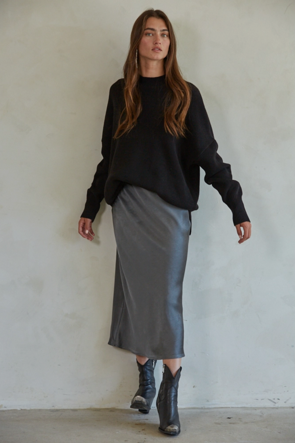 model wearing classic black sweater and midi skirt