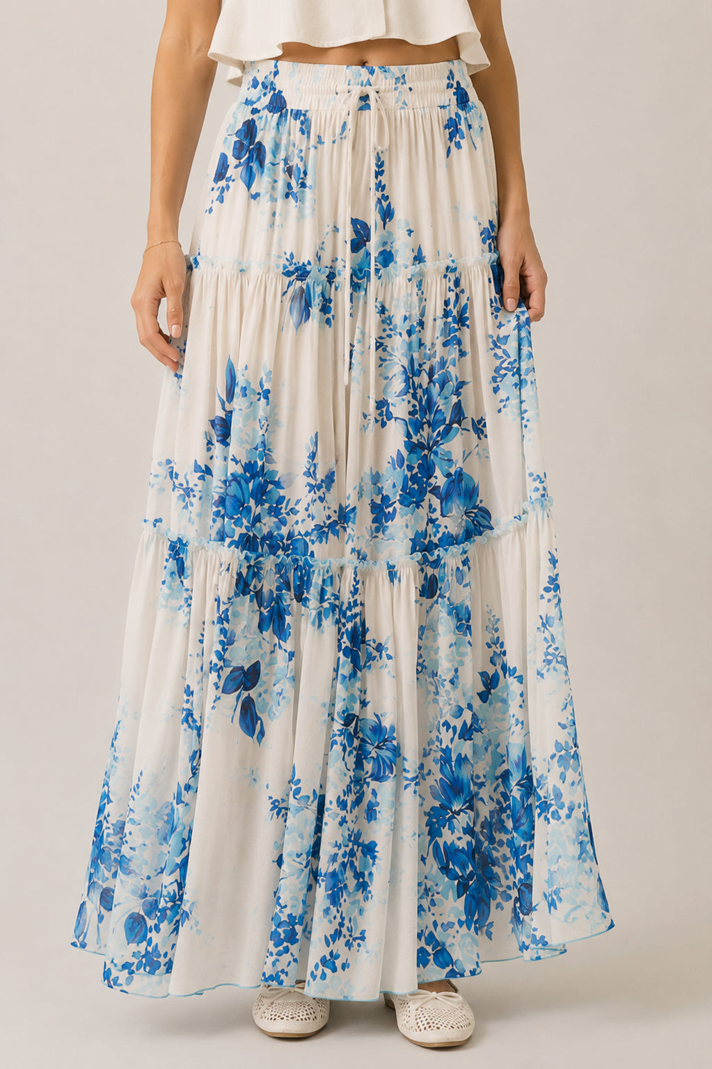 Long floral skirt with blue flowers on a plain background