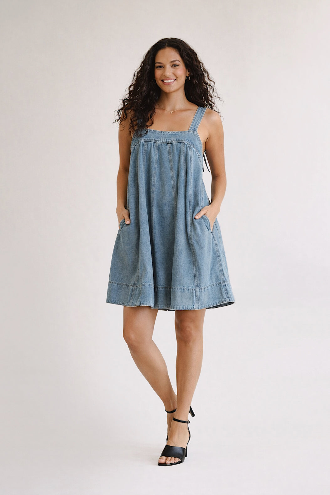 Woman wearing a blue dress on a white background