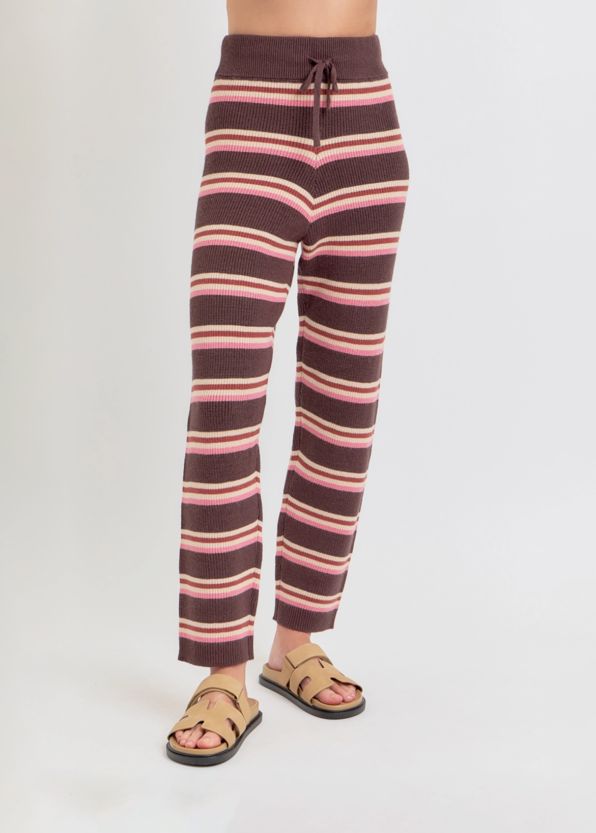 Striped pants worn by a person on a white background